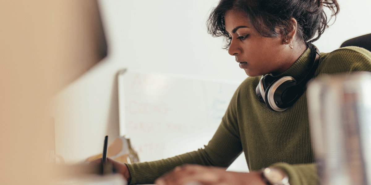 A data analyst sitting at a desk