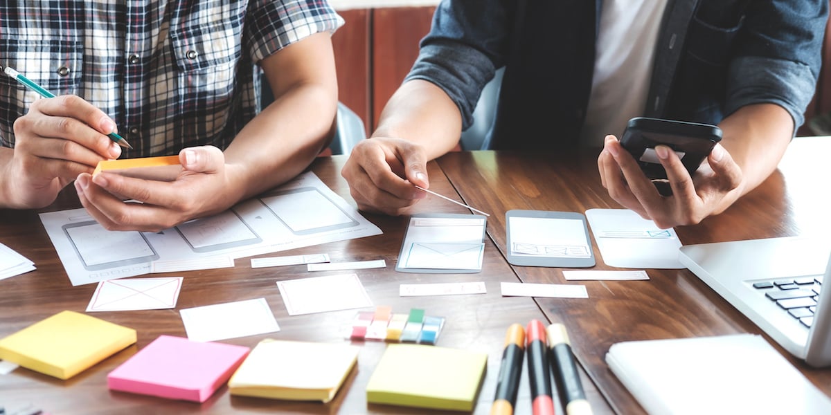 Two UX designers discussing a wireframe